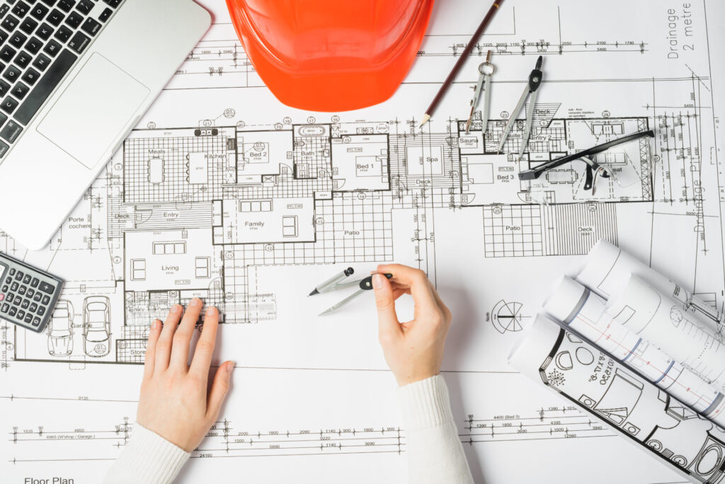 worker drawing blueprint